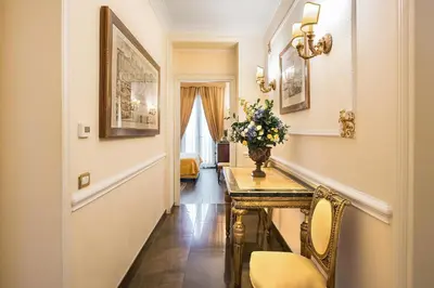 a hallway with a table with a vase of flowers on it at Alta Luxury Apartments - Oca Apartment in Rome
