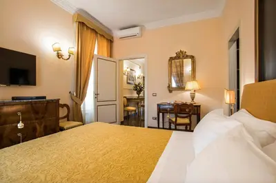 a hotel room with a bed and a desk at Alta Luxury Apartments - Oca Apartment in Rome