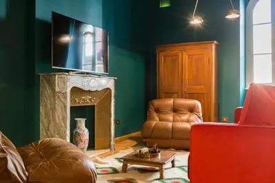 a living room with a tv and a couch and a chair at Glamour Leonina - Monti in Rome