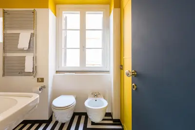 a bathroom with a toilet and a sink and a window at Glamour Leonina - Monti in Rome
