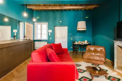 a living room with a red couch and a table at Glamour Leonina - Monti in Rome