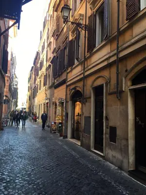 a cobblestone street in a city with buildings at Glamour Leonina - Monti in Rome