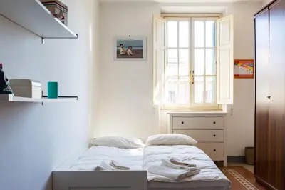 a small bedroom with a bed and a window at PIAZZA MAZZINI APARTMENT in Rome