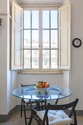 a table with a bowl of fruit on it in a kitchen at PIAZZA MAZZINI APARTMENT in Rome