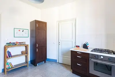 a kitchen with a stove and a cabinet in it at PIAZZA MAZZINI APARTMENT in Rome