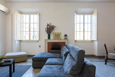 a living room with a couch and a fireplace at PIAZZA MAZZINI APARTMENT in Rome