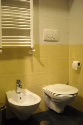 a bathroom with a white toilet and a sink at B&B Il Granello Di Senape in Rome
