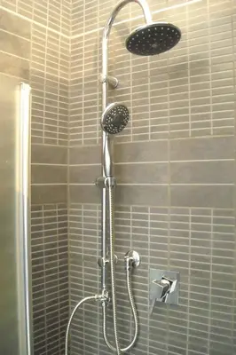 a shower with a shower head in a bathroom at B&B Il Granello Di Senape in Rome