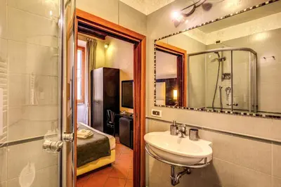 a bathroom with a sink and a mirror and a tub at Guest House o Affittacamere Magenta Fico 2 in Rome
