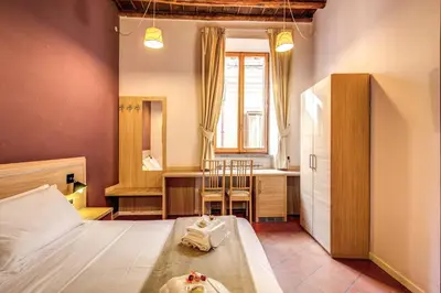 a bedroom with a bed and a desk and a table at Guest House o Affittacamere Magenta Fico 2 in Rome