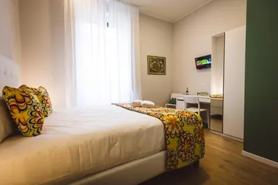 a bedroom with a large bed with a window at Angelina Rooms in Rome in Rome