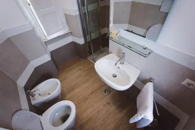 a small bathroom with a toilet and a sink at Angelina Rooms in Rome in Rome