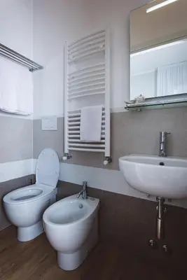 a bathroom with a white toilet and a sink at Angelina Rooms in Rome in Rome