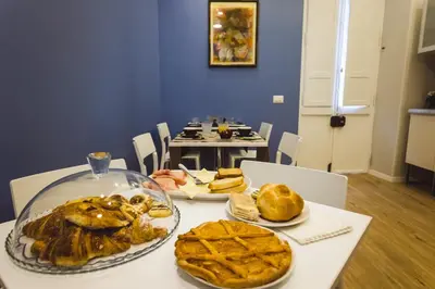 a table with plates of food on top of it at Angelina Rooms in Rome in Rome