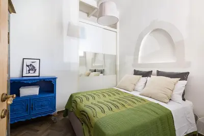 a bedroom with a bed and a blue cabinet at Sara Apartment - Campo de Fiori 35 in Rome