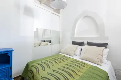 a bedroom with a bed with a green and white blanket at Sara Apartment - Campo de Fiori 35 in Rome