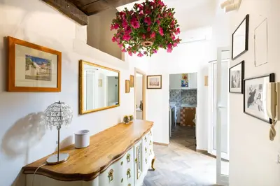 a home office with a wooden counter and flowers on the wall at Sara Apartment - Campo de Fiori 35 in Rome