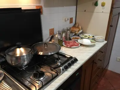 a kitchen counter with pots and pans on a stove at Lovely Irnerio ❤ flat near S. Pietro ★ in Rome