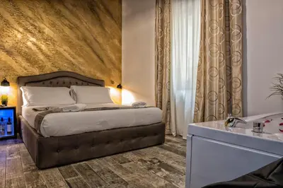 a bedroom with a large bed and a sink at StarHome Navona in Rome
