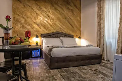 a bedroom with a bed and a table in a room at StarHome Navona in Rome