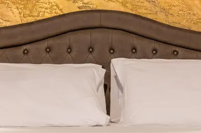 a bed with two white pillows on top of it at StarHome Navona in Rome