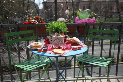 a table with two chairs and a plate of food on it at Roma Gianicolense in Rome