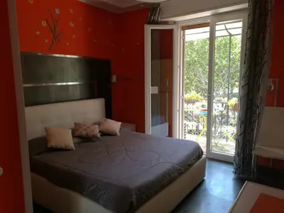 a bedroom with a bed in a room with red walls at Roma Gianicolense in Rome