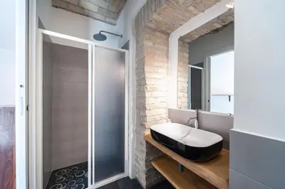a bathroom with a sink and a glass shower at Il Giardino Dell'Argano Rosso in Rome