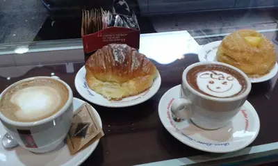 two cups of coffee and two pastries on a table at Il Giardino Dell'Argano Rosso in Rome