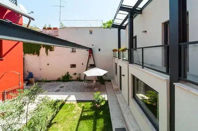 an internal courtyard of a building with an umbrella at Il Giardino Dell'Argano Rosso in Rome