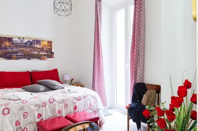 a bedroom with a bed with red pillows at Sixty One Luxury Room in Rome