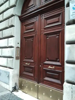 a large wooden door on the side of a building at Sixty One Luxury Room in Rome