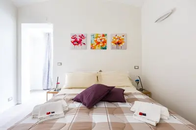a bedroom with a large bed with towels on it at Sixty One Luxury Room in Rome