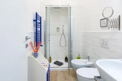 a bathroom with a shower and a toilet and a sink at Sixty One Luxury Room in Rome