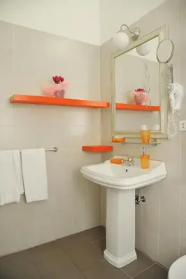 a bathroom with a sink and a mirror and towels at Locanda al Viminale in Rome