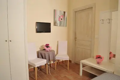 a room with a table and two white chairs and a mirror at Locanda al Viminale in Rome