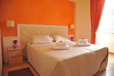 a bedroom with a white bed with two towels on it at Locanda al Viminale in Rome