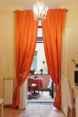 an open door with orange curtains in a room at Locanda al Viminale in Rome