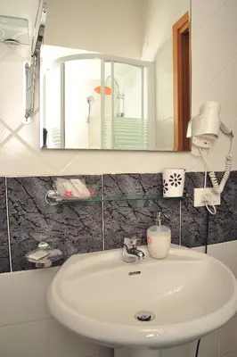a bathroom with a white sink and a mirror at Locanda al Viminale in Rome