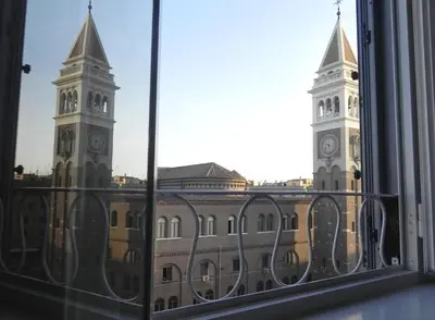 a view of a building with a clock tower from a window at LINE-UP Apartment in Rome