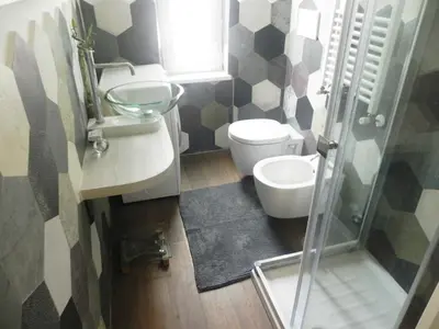 a bathroom with a toilet and a sink and a shower at LINE-UP Apartment in Rome