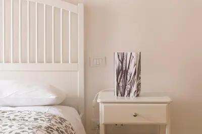 a bedroom with a bed and a nightstand with a vase on it at Art Apartment Navona Square in Rome