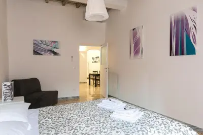 a bedroom with a bed and a living room at Art Apartment Navona Square in Rome