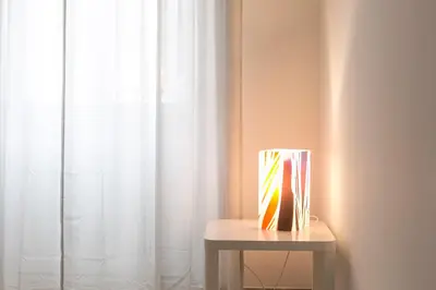 a vase sitting on a table next to a window at Art Apartment Navona Square in Rome