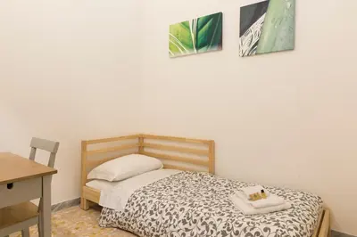 a bedroom with a bed and two pictures on the wall at Art Apartment Navona Square in Rome