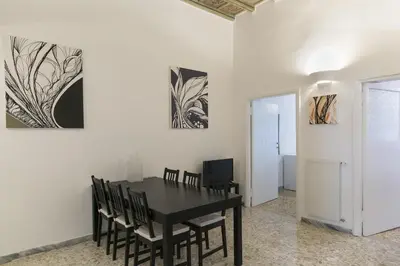 a dining room with a black table and chairs at Art Apartment Navona Square in Rome