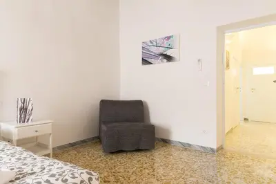 a bedroom with a chair next to a bed at Art Apartment Navona Square in Rome
