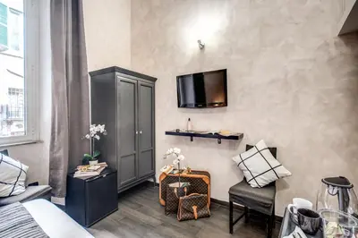 a room with a bed and a tv on a wall at La Residenza Dell'Angelo in Rome