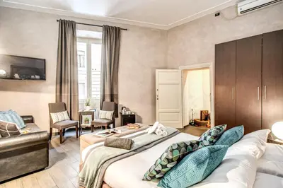 a hotel room with two beds and a couch at La Residenza Dell'Angelo in Rome
