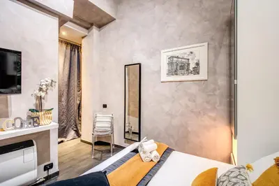 a hotel room with a bed and a mirror at La Residenza Dell'Angelo in Rome